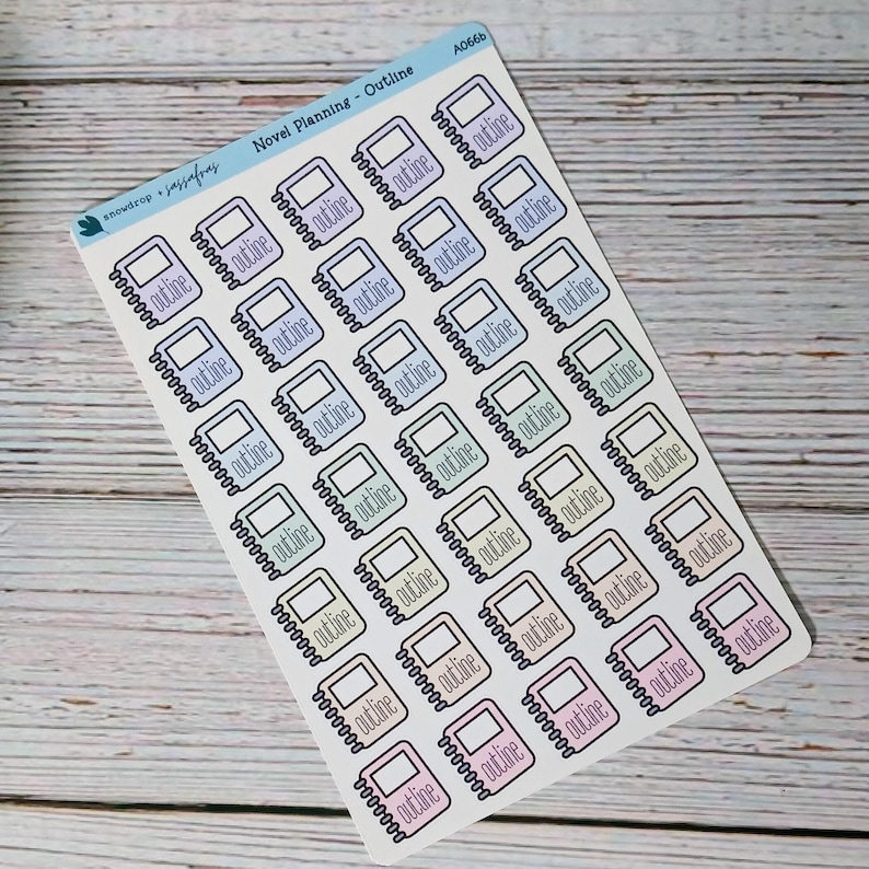 May include: A sticker sheet featuring multiple notebook-shaped stickers with the word "outline" printed on them. The stickers are in various pastel colors, including pink, purple, and green. The sheet is labeled "Novel Planning - Outline".