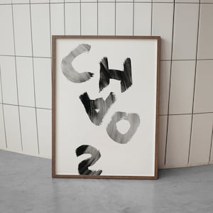 May include: A framed black and white abstract art print with the word "Chaos" written in bold, brushstroke letters.