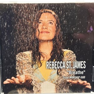 May include: CD case featuring Rebecca St. James with the title "Breathe" from Worship God. The cover art shows a woman looking upwards in the rain. The CD case is in a clear plastic jewel case.