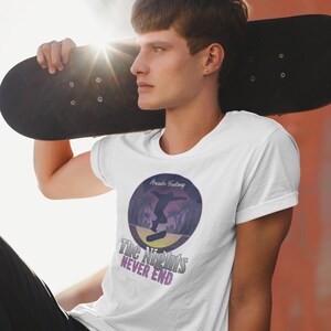 May include: White t-shirt with a graphic of a person skateboarding in front of a sunset with the text "Route Feeling" and "The Nights Never End".