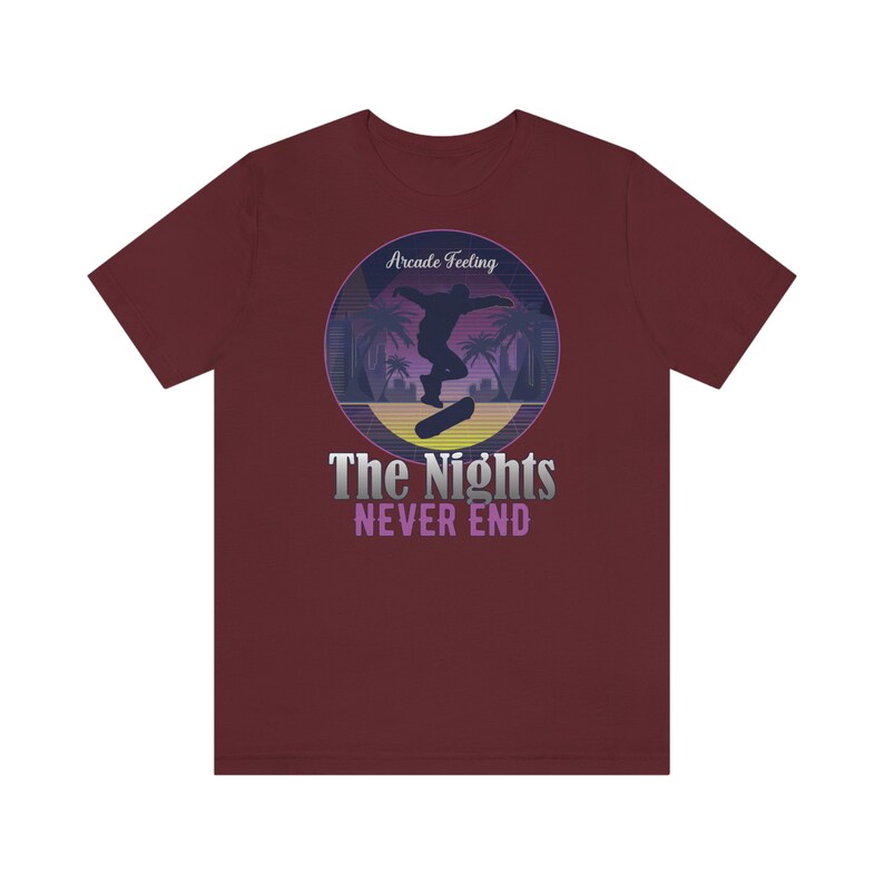 May include: A maroon t-shirt with a retro-style graphic of a skateboarder in silhouette, palm trees, and the text "Arcade Feeling The Nights NEVER END".