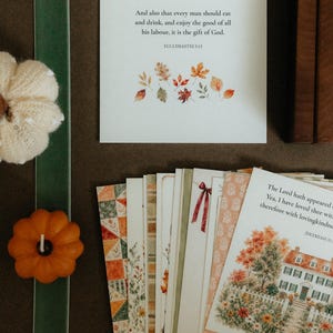 May include: A collection of rectangular cards featuring watercolor illustrations of autumn leaves, a house, and floral patterns. One card displays the text: And also that every man should eat and drink, and enjoy the good of all his labour, it is the gift of God. ECCLESIASTES 3:13.