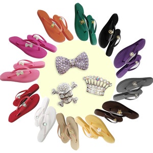 May include: A variety of colorful flip-flops with different embellishments, including a bow, a crown, and a skull and crossbones. The flip-flops are arranged in a circle on a white background.