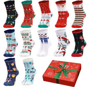 May include: A collection of colorful Christmas socks with various festive designs, including snowmen, Santa Claus, and holiday patterns. The socks are displayed with a red gift box tied with a green ribbon.