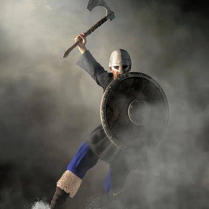 May include: A Viking warrior in full battle gear, wielding an axe and shield. The warrior is clad in chainmail, a helmet, and blue trousers. The axe is raised high, suggesting action. The background is a misty, atmospheric scene.