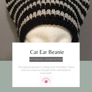 May include: A black and gray striped cat ear beanie. The beanie has a rounded top with two pointed ears. The text on the image says "Cat Ear Beanie" and "PATTERN BY LIVCROCHETSCO". The pattern is beginner-friendly and comes in two sizes.