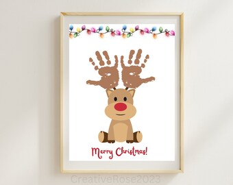 May include: A printable Christmas craft featuring a reindeer with handprint antlers. The reindeer is brown with a red nose and the text "Merry Christmas!" is printed below.