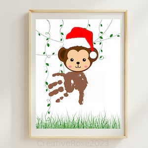 May include: A brown handprint monkey wearing a red Santa hat with white trim. The monkey is surrounded by green vines and grass.