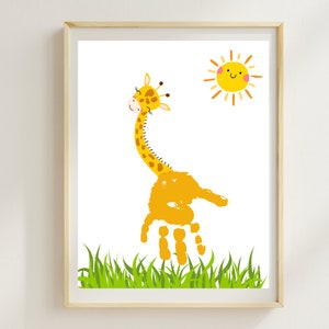 May include: A yellow giraffe handprint art print with a smiling sun and green grass. The giraffe has brown spots and a long neck.
