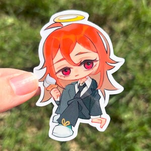 May include: A sticker depicting a cartoon character with red hair, red eyes, and a halo. The character is wearing a black suit and holding an ice cream cone. The sticker has a white border and is set against a green background.
