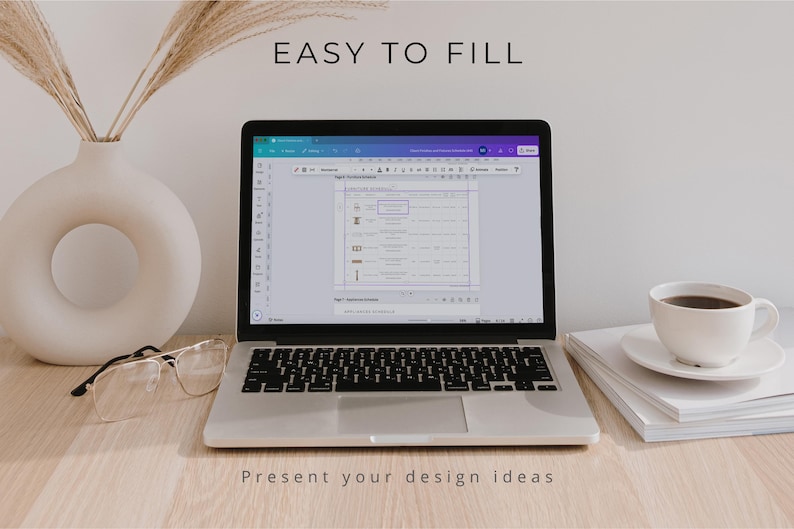 May include: A silver laptop displaying a digital document with the text EASY TO FILL and PRESENT your design ideas. The screen shows a table layout with icons and text. Beside the laptop are clear glasses, a white vase, and a coffee cup.