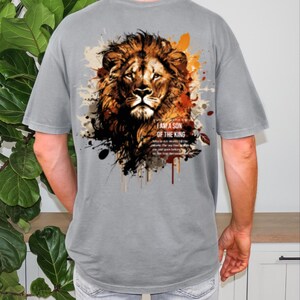 May include: Gray t-shirt featuring a detailed lion graphic with brown, orange, and black accents. The text "I AM A SON OF THE KING" is printed below the lion's head. The shirt has short sleeves and a relaxed fit.