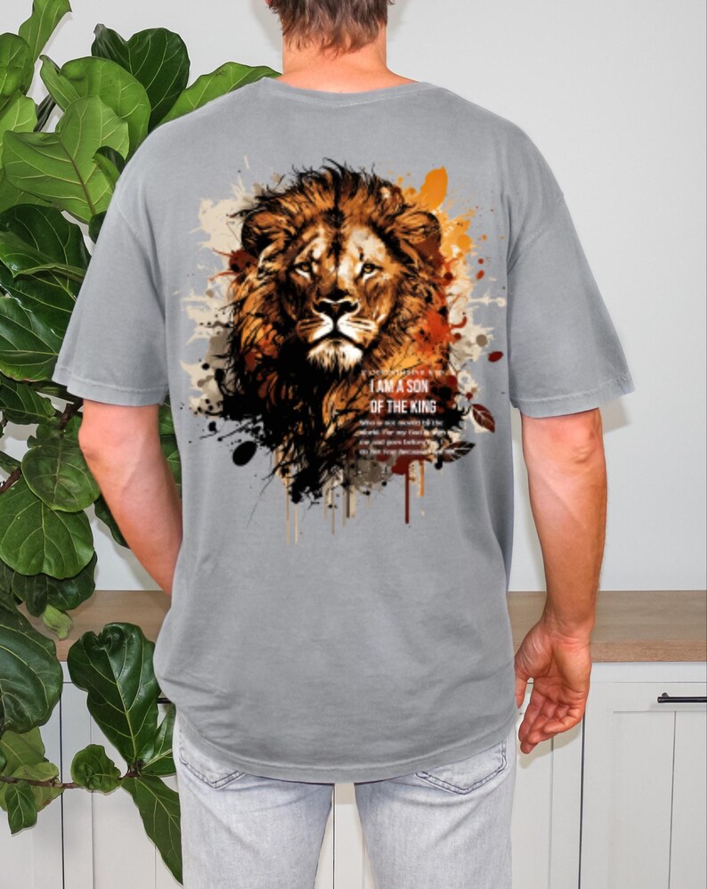 May include: Gray t-shirt featuring a detailed lion graphic with brown, orange, and black accents. The text "I AM A SON OF THE KING" is printed below the lion's head. The shirt has short sleeves and a relaxed fit.