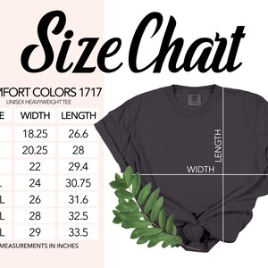May include: A dark gray unisex heavyweight tee shirt with a size chart. The chart lists sizes S to 4XL, with width measurements from 18.25 to 29 inches and lengths from 26.6 to 33.5 inches. The text "Size Chart" is at the top.
