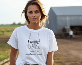 May include: White t-shirt with a black line drawing of a camera with a strap and the text "Just a vintage soul".
