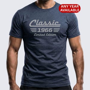 May include: A navy blue t-shirt featuring the text "Classic 1966 Limited Edition" in light grey. A red circle in the top right corner says "Any Year Available".