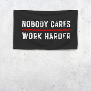 May include: A white ceramic mug with a black handle and the text "But First, Coffee" in a handwritten style. The mug is on a white surface. The mug is approximately 4 inches tall.