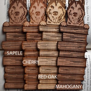 May include: Four wooden bookmarks with a laser-engraved image of a husky dog peeking over a stack of books. The bookmarks are made of different types of wood: Sapele, Cherry, Red Oak, and Mahogany.