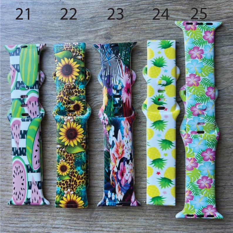 May include: Five different Apple Watch bands with various colorful and patterned designs. The bands are numbered 21 through 25.