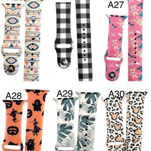 May include: A selection of patterned watch straps. Designs include geometric patterns, black and white gingham, teddy bears, Halloween characters, tropical leaves, and leopard print. Each strap has a metal clasp.