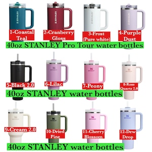 May include: A collection of twelve 40oz STANLEY Pro Tour water bottles in various colors, including teal, cranberry gloss, frost, purple dust, black, lilac, peony, rose quartz, cream, dried pine, cherry blossom, and dew drop. Each bottle has a handle and a straw.
