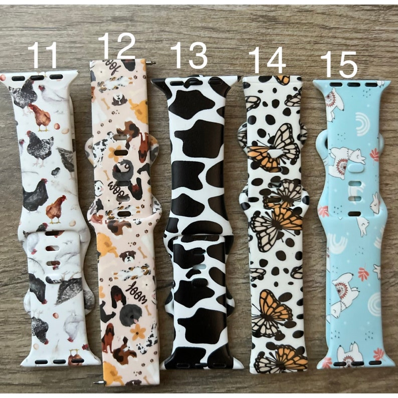 May include: Five different Apple Watch bands with various patterns. The bands are numbered 11 through 15. The patterns include chickens, dogs, cows, butterflies, and llamas.