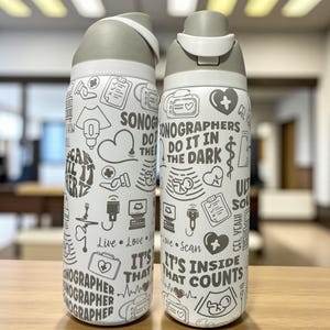 May include: Two white water bottles with gray lids, covered in black and white medical-themed illustrations and text. The text includes phrases like "Sonographers do it in the dark" and "It's inside that counts."