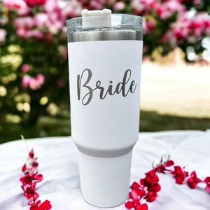 May include: White stainless steel tumbler with a white lid and the word "Bride" in gray script on the side.