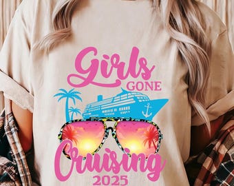 May include: A white t-shirt with a pink graphic design that says "Girls Gone Cruising 2025". The graphic also includes a blue cruise ship, palm trees, and sunglasses with a sunset reflection.