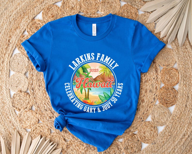 May include: Royal blue t-shirt featuring a circular design with the text "Larkins Family Hawaii Celebrating Gary & Judy 50 Years 2025". The design includes palm trees, a beach scene, and tropical foliage.