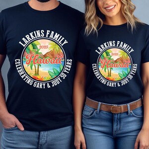 May include: Navy blue t-shirts featuring a circular design with the text "Larkins Family Hawaii 2025 Celebrating Gary & Judy 50 Years." The design includes palm trees, a beach scene, and mountains.