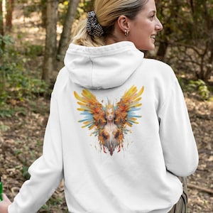 May include: White hooded sweatshirt with a colorful graphic print of a woman with wings on the back.