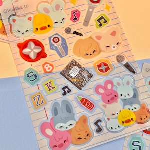 May include: A sheet of colorful stickers featuring cartoon animals, musical notes, microphones, and other decorative elements. The stickers include bunnies, ducks, and foxes in pastel colors. The text "OHWHALE.CO" is visible.