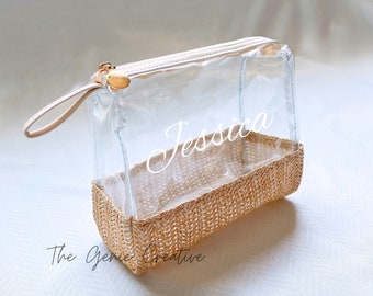 May include: Clear plastic zippered pouch with a woven straw bottom. The pouch has a gold zipper pull and the name "Jessica" is printed on the front.