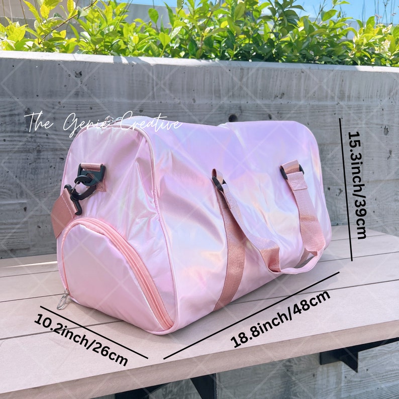 May include: A pink iridescent travel duffel bag with black straps and a zipper closure. The bag measures 10.2 inches by 18.8 inches by 15.3 inches.