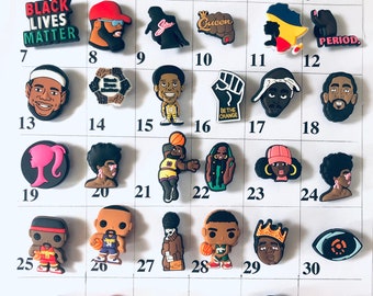 May include: A set of 36 colorful shoe charms featuring various designs, including basketball players, cartoon characters, and social justice messages. The charms are arranged in a grid pattern on a white background.