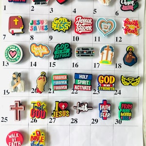 May include: A set of 36 colorful shoe charms with religious themes. The charms feature various Christian symbols, phrases, and images, including crosses, hearts, angels, and bible verses.