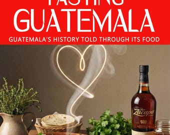 May include: A book cover titled "Tasting Guatemala" with the subtitle "Guatemala's History Told Through Its Food." The image features a table set with a meal, including a bowl of stew, tortillas, and a bottle of Zacapa rum.
