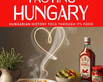 May include: A cookbook cover titled "Tasting Hungary" with the subtitle "Hungarian History Told Through Its Food." The image features a bowl of stew, paprika, bread, and other Hungarian food items. A heart-shaped design is highlighted with steam.