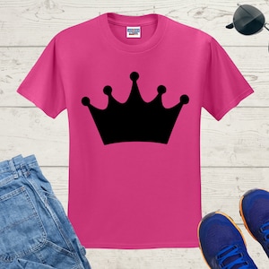 May include: A pink t-shirt with a black crown graphic printed on the front.