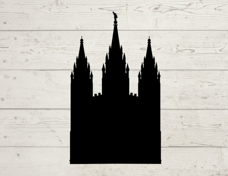 May include: A black silhouette of a temple with three spires, set against a light wood grain background. The central spire is the tallest, topped with a statue. The design is a simple, graphic representation of a religious building.