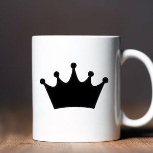 May include: White ceramic mug with a black crown design.