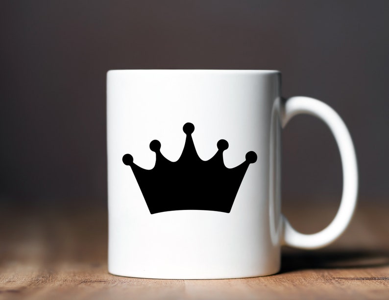 May include: White ceramic mug with a black crown design.