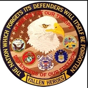 May include: A round, blue and yellow patch with a bald eagle in the center. The eagle is facing right and has a yellow beak. The patch has the text "The Nation Which Forgets Its Defenders Will Itself Be Forgotten" around the outside. The text "In Memory Of Our Troops" is in the center of the patch. There are five smaller patches around the eagle, representing the different branches of the US military.