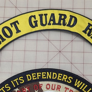May include: Yellow and black embroidered motorcycle patch with the text "PATRIOT GUARD RIDERS" in an arched shape.