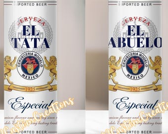 May include: Two white insulated tumblers with a straw, featuring a design reminiscent of a beer can. One reads "EL TATA" and the other "EL ABUELO" in blue. The design includes a silver wreath, a red and blue emblem, and the word "Especial".