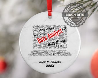 May include: White round ceramic ornament with a black and white word cloud depicting the skills and responsibilities of a data analyst. The word "Data Analyst" is highlighted in red. The ornament is personalized with the name "Alex Michaels" and the year "202X".