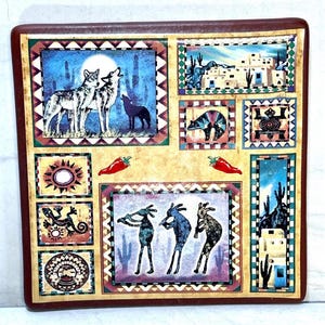 May include: A square decorative tile with a dark brown border featuring multiple southwestern-themed illustrations including howling wolves, adobe buildings, a bear, a lizard, a sun, and three flute-playing figures, accented by two red chilli peppers.