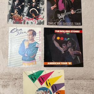 May include: A set of three ceramic mugs with a speckled, matte finish. The mugs are in shades of cream, light gray, and dark gray. Each mug has a simple, minimalist design, perfect for coffee or tea.