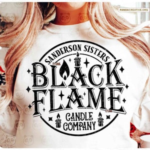 May include: A white sweatshirt featuring a black graphic design with the text "Sanderson Sisters Black Flame Candle Company." The design includes candles and stars. The image also shows digital download options.